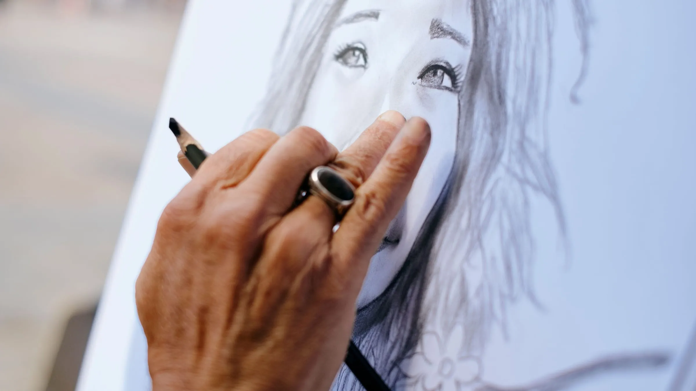 Soulmate sketch reviews: a close look at a pencil portrait of a woman, with a hand resting on the paper